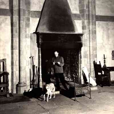 1930-1945 JHHJr & dog - Poofie at Great Hall fireplace