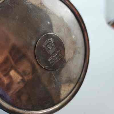 Bottom of silver candelabrum with makers mark "Hand chased silver on copper. Made in England. Folgate."