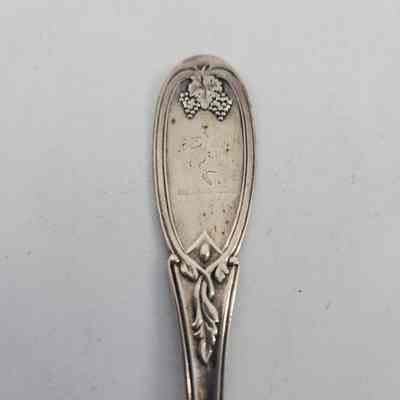 Handle of spoon with grape and vine design and a squirrel engraving