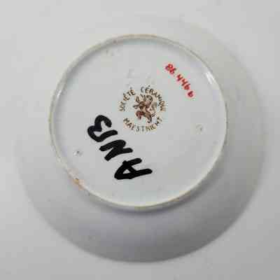Bottom of saucer with maker's mark "Societe Ceramique Maestricht" and "ANB" written in black