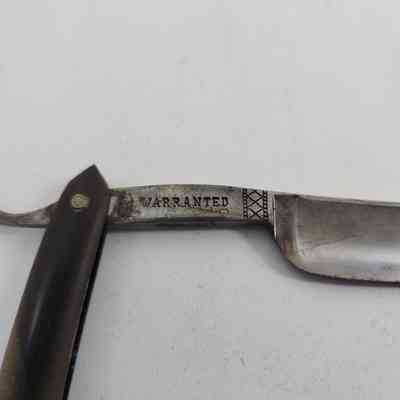 "WARRANTED" engraved on blade