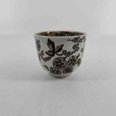 White teacup with brown floral design