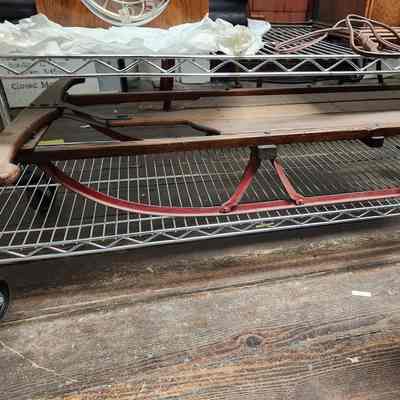 Winter sled made from wood and red, metal frame
