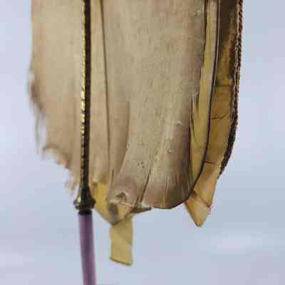 Candle screen fabric separated at seam showing backing