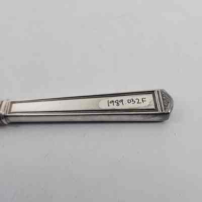 Back of silver dinner knife with accession number