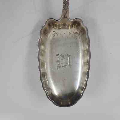 Oval spoon head with "M" engraved