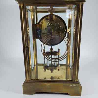 Back of brass clock with glass sides