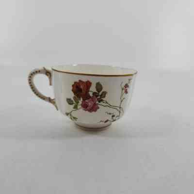 Reverse side of teacup with red and pink floral design