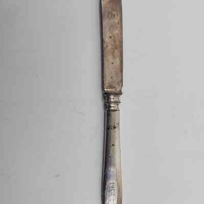 Back of knife with accession number showing discoloration