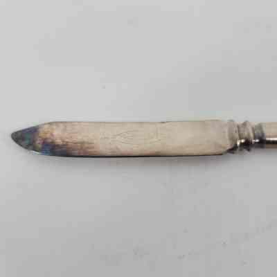 Engraving of "1847 Rogers Bros Warranted" and discoloration around tip of the blade