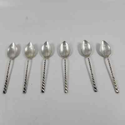 Set of six silver demitasse spoons with twisted handles and "M" monogrammed on the bowl
