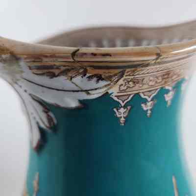 Damage to rim of pitcher that has been repaired
