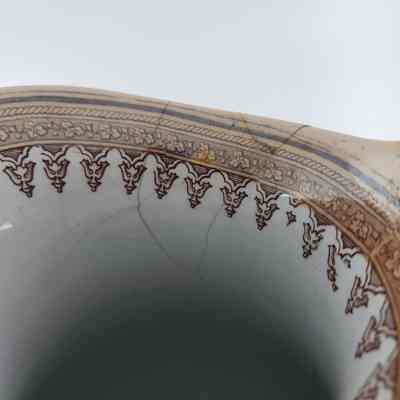 Cracks along rim of pitcher