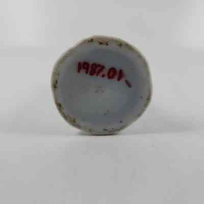 Bottom of hatpin holder with accession number written in red