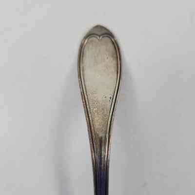 Handle of silver sauce ladle