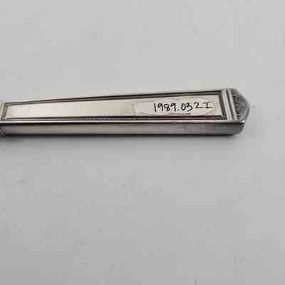 Back of silver dinner knife with accession number