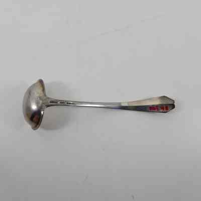 Back of silver ladle with accession number