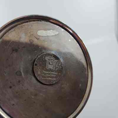 Bottom of silver candelabrum with makers mark "Hand chased silver on copper. Made in England. Folgate."