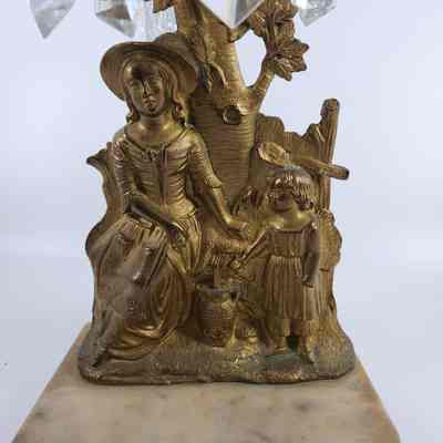 Brass depiction of a woman and child