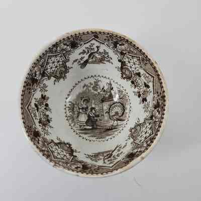 Inner cup with design of two people with a peacock