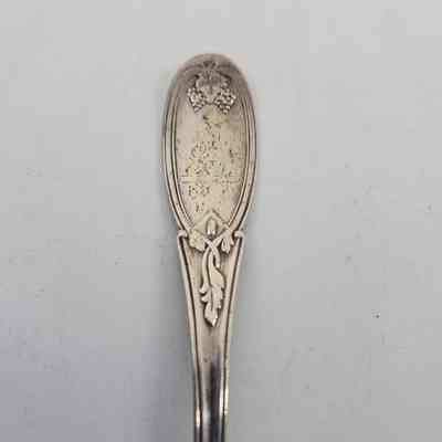 Handle of spoon with grape and vine design and a squirrel engraving