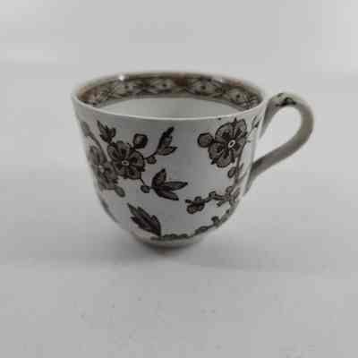 White teacup with brown floral design