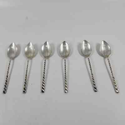 Set of six silver demitasse spoons with twisted handles and "M" monogrammed on the bowl