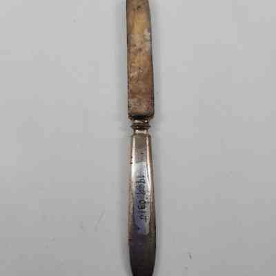 Back of fruit knife with accession number. Shows discoloration