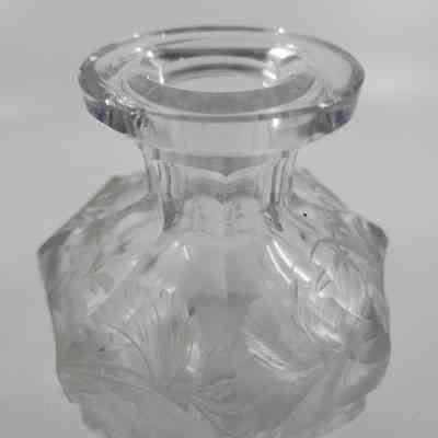 Glass cologne bottle with floral engraving