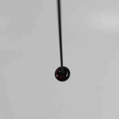 Accession number "86.557" lacquered on bottom of pinhead