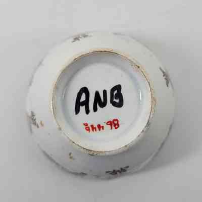 Bottom of cup with "ANB" written in black