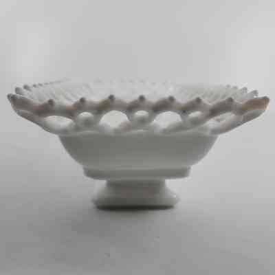 Side of white milk glass box with lace pattern rim