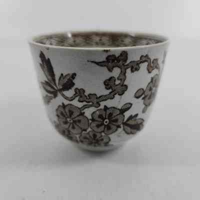 White teacup with brown floral design
