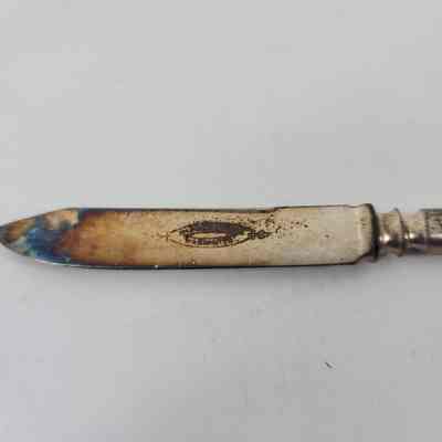 Engraving "1847 Rogers Bros Warranted" discolored with tip of blade also discolored
