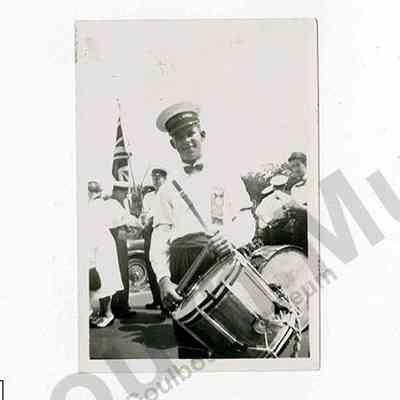 Photograph: Roy McCooeye wearing Stittsville O.Y.B. cap and ribbon holding a drum, taken 1956