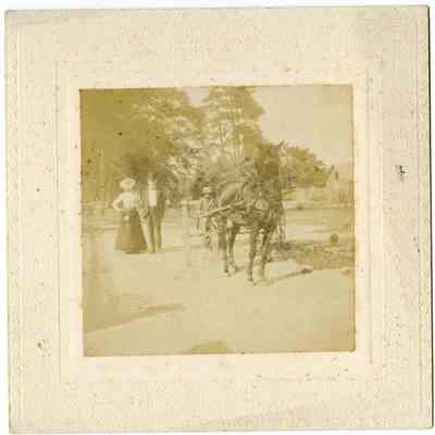 Man and Woman Walking Towards Horse Drawn Wagon