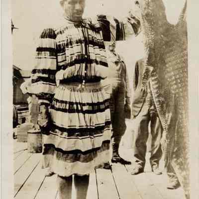 Seminole Indian Shirt Tail Charlie Standing with an Alligator