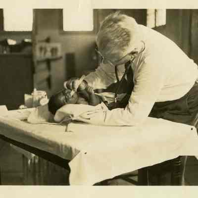 Housing Authority Doctor Examining an African-American Baby