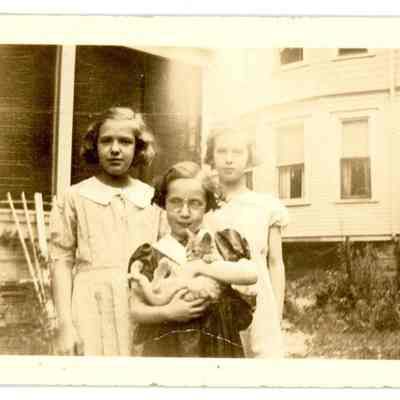 Three Young Girls with a Kitten