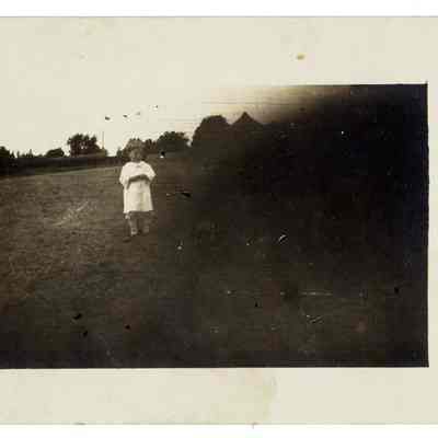 Child standing in yard