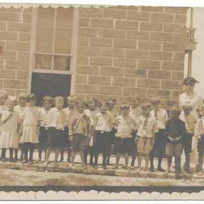Class of Schoolchildren Standing Next to the Second Schoolhouse