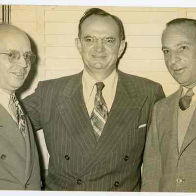 August Jr. with two unidentified men