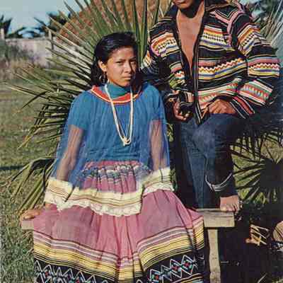 A young Seminole Indian brave and his bride on their reservation in Florida.