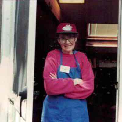 Volunteer poses outside Education Shed