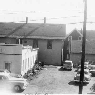 2024.14.14: Written on the back: "This was taken from my house on Northfield St. See the store is about a foot and a half from the building; it is to hitch on to?"