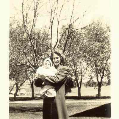 Photo of Mrs. Kay (Vander Woude) Riel holding their child Walter Jr.