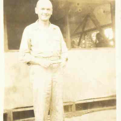 Photo of Lt. Cerney of Communications in front of tent on the island of Morati during WWII.