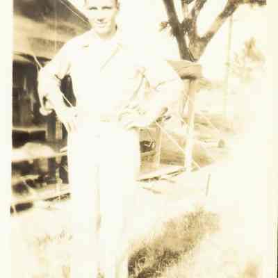 Photo of Mr. Riel man in front of tent on Moratai during WWII.