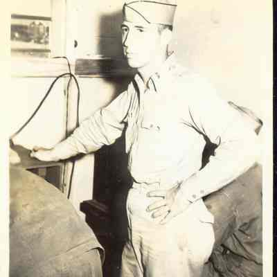 Photo of man inside tent during WWII.