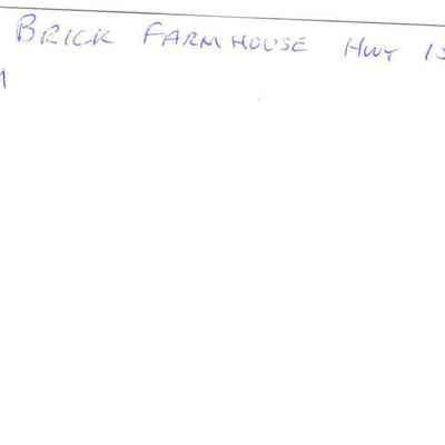 Back of photo of brick farmhouse